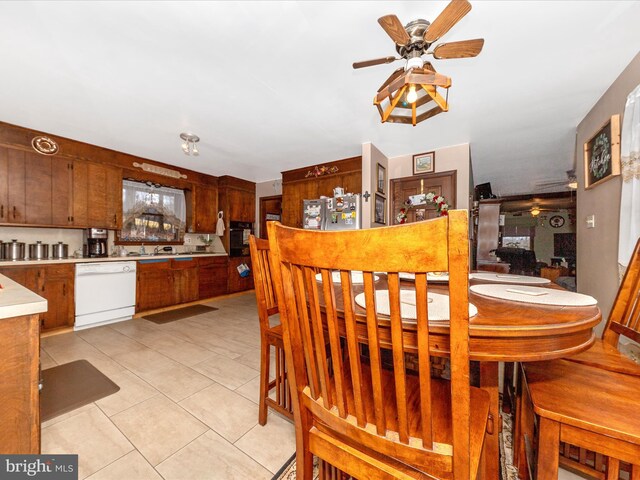 dining room featuring ceiling fan and light tile patterned flooring