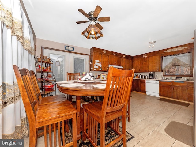 tiled dining space featuring french doors and ceiling fan