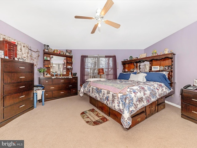 bedroom with ceiling fan and light carpet