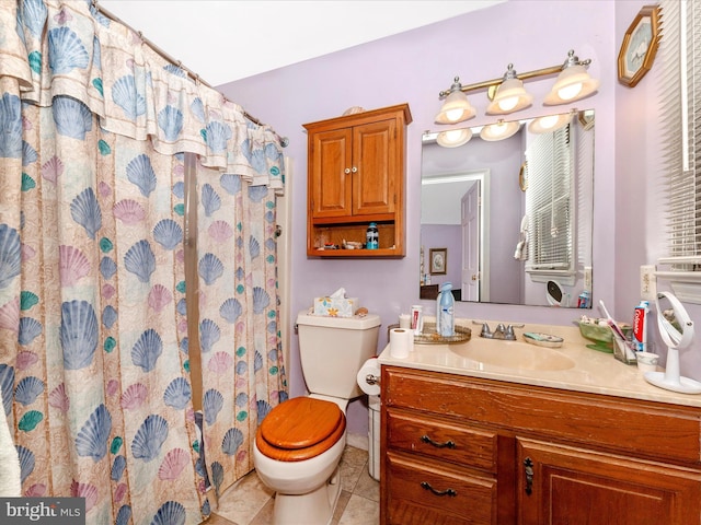 bathroom with tile patterned floors, walk in shower, vanity, and toilet