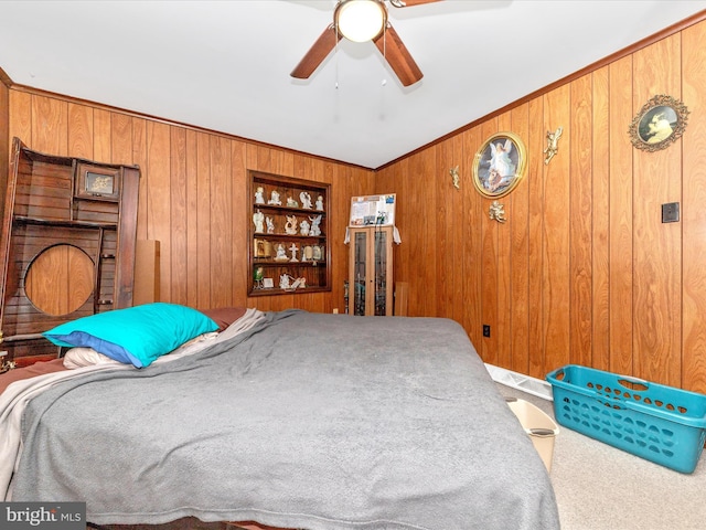 bedroom with carpet floors, ceiling fan, and wooden walls