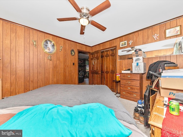 bedroom featuring carpet flooring, wood walls, and a closet