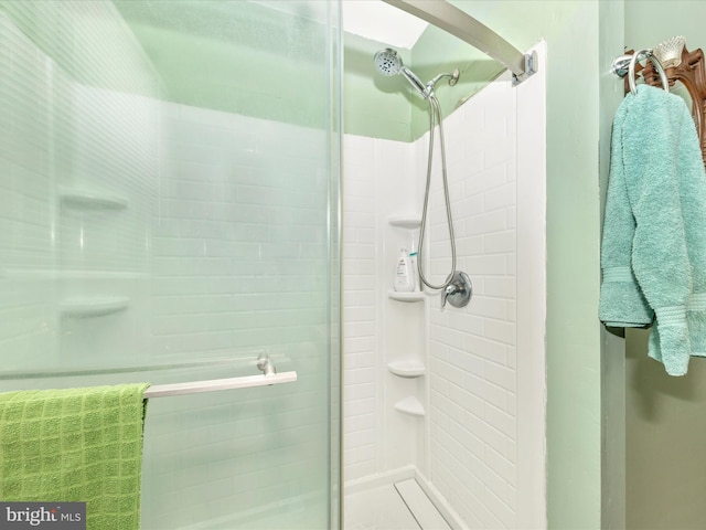 bathroom with a shower with shower door