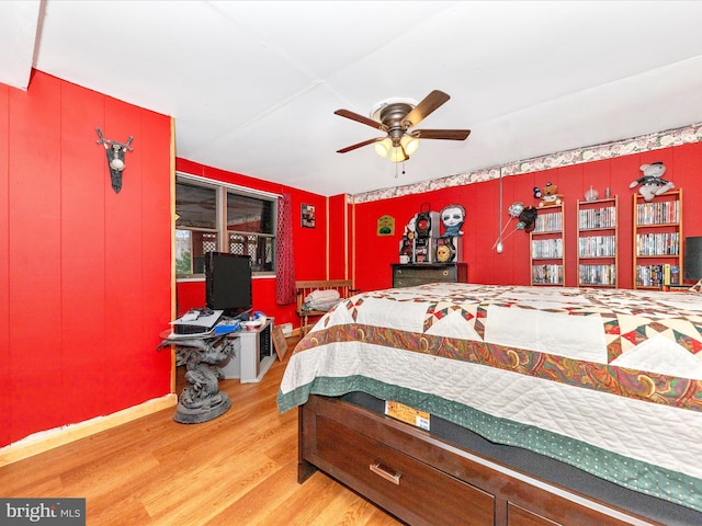 bedroom with ceiling fan and hardwood / wood-style floors