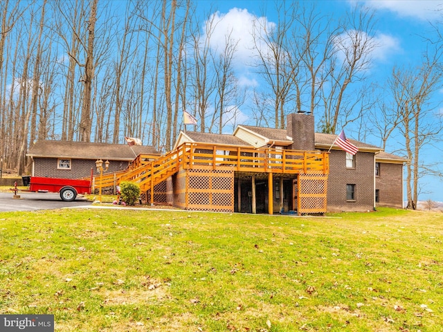 back of property featuring a lawn and a deck