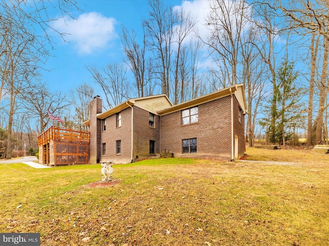 back of property featuring a deck and a yard