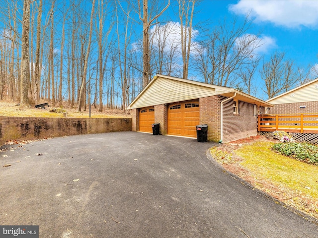 view of home's exterior with an outbuilding, a garage, and a wooden deck