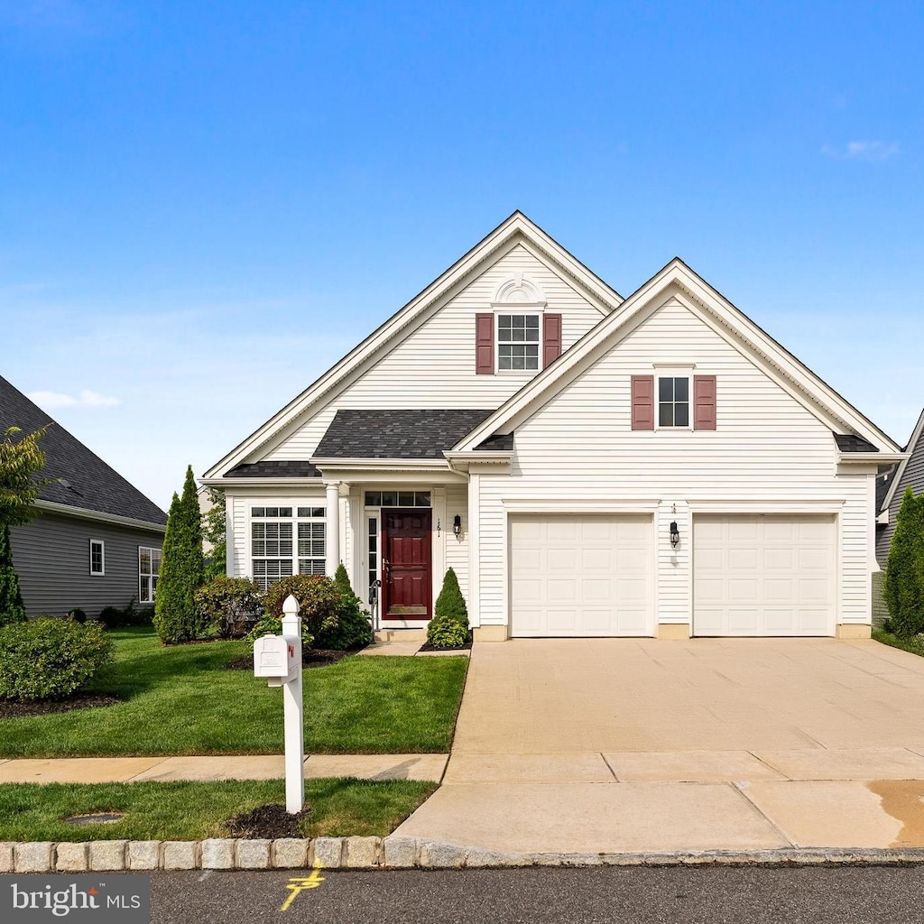 view of front property with a garage and a front lawn