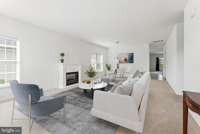 living room featuring light carpet and a healthy amount of sunlight