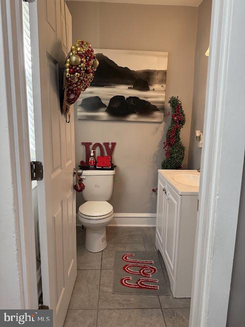 bathroom with tile patterned floors, vanity, toilet, and plenty of natural light