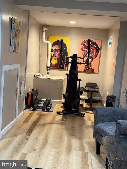 workout area with light wood-type flooring