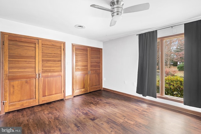 unfurnished bedroom featuring dark hardwood / wood-style flooring and ceiling fan