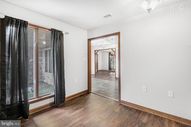 spare room with dark wood-type flooring