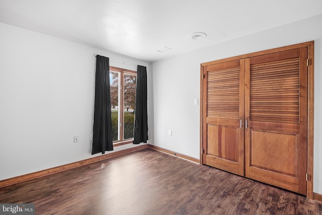 unfurnished bedroom featuring dark hardwood / wood-style flooring