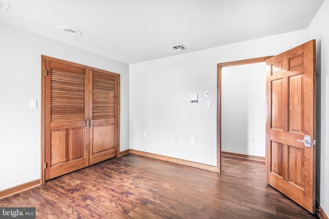 unfurnished bedroom featuring dark hardwood / wood-style flooring