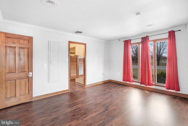 spare room with dark hardwood / wood-style floors and ornamental molding