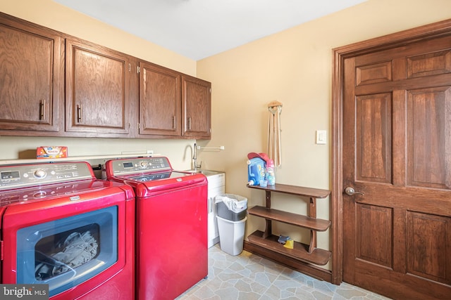 laundry area with cabinets and washer and clothes dryer