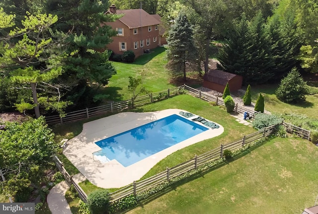 view of swimming pool featuring a rural view and a yard