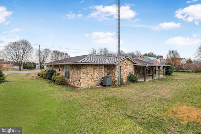 view of side of home featuring a lawn, a patio area, and central air condition unit