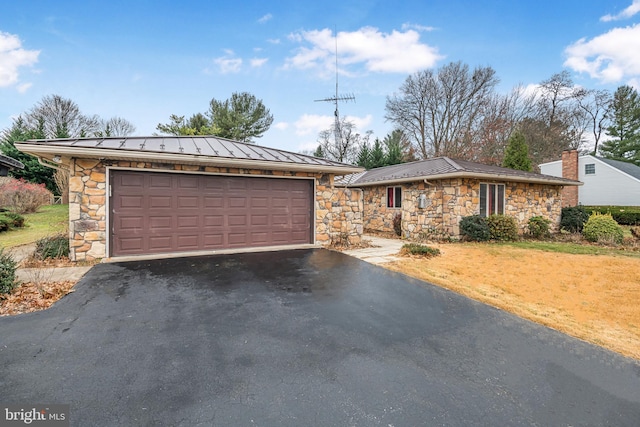 single story home with an outbuilding and a garage