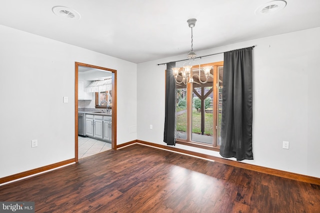 unfurnished dining area featuring light hardwood / wood-style flooring and an inviting chandelier