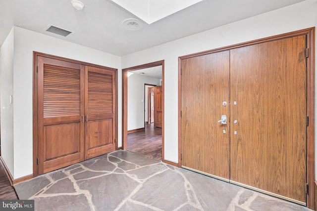 unfurnished bedroom featuring dark hardwood / wood-style flooring and a closet