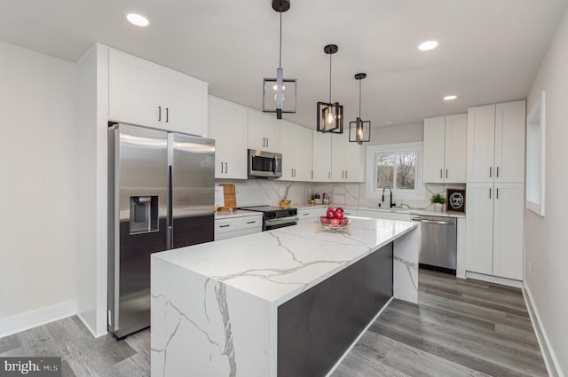 kitchen with a center island, white cabinets, and stainless steel appliances