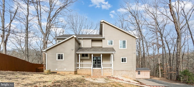 rear view of property featuring covered porch