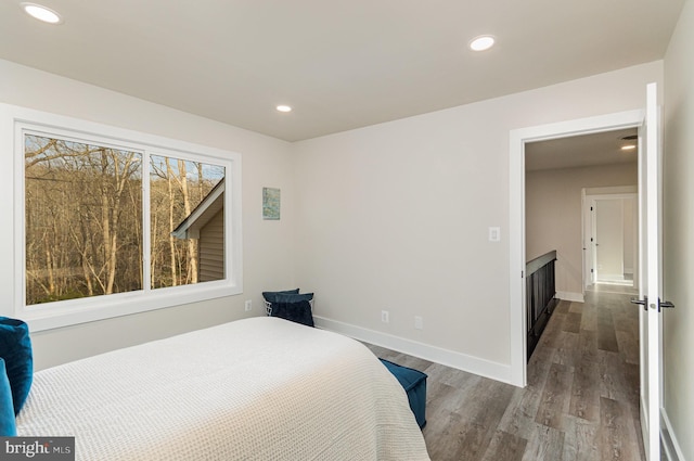 bedroom featuring dark wood-type flooring and multiple windows