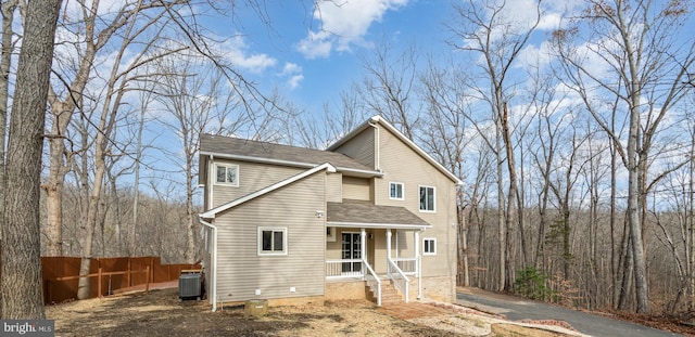 view of front of home with covered porch and central AC unit