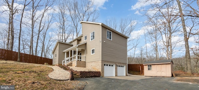 view of home's exterior featuring a storage unit and a garage