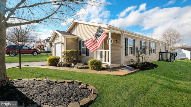 view of side of home featuring a porch, a garage, and a lawn