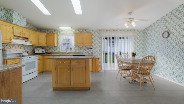 kitchen with white electric range oven, light tile patterned floors, ceiling fan, and sink