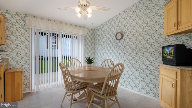 dining space featuring ceiling fan and light tile patterned floors