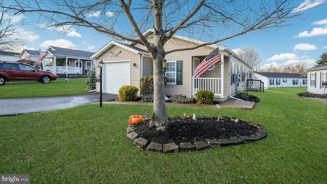 view of property exterior with a porch, a garage, and a yard