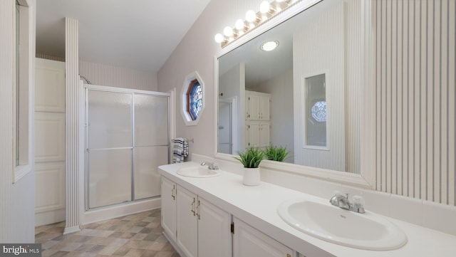 bathroom featuring vanity and a shower with shower door