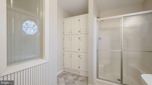 bathroom with a shower with shower door