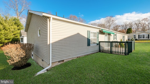 view of home's exterior featuring a yard and a wooden deck