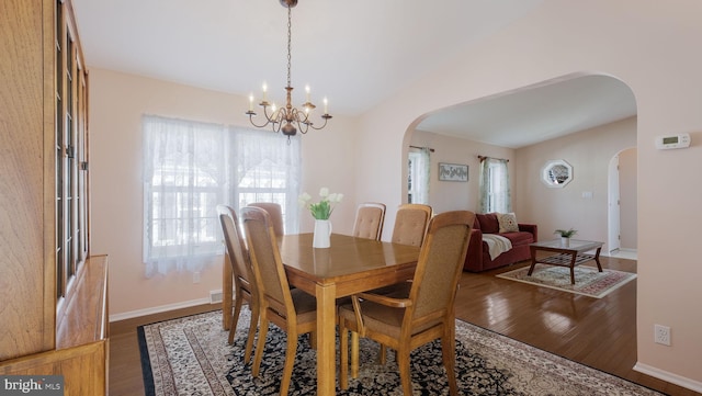 dining space with a chandelier and dark hardwood / wood-style flooring