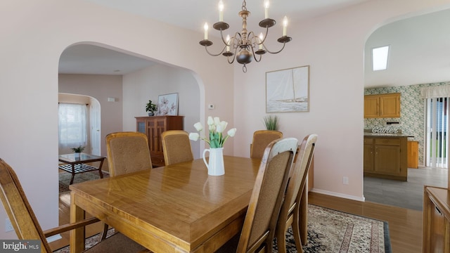 dining area featuring light hardwood / wood-style flooring and an inviting chandelier