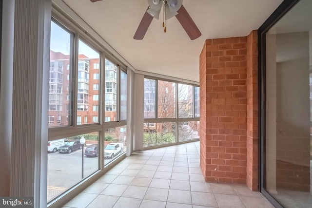 unfurnished sunroom with plenty of natural light and ceiling fan