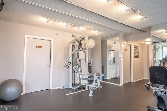 workout area with a textured ceiling