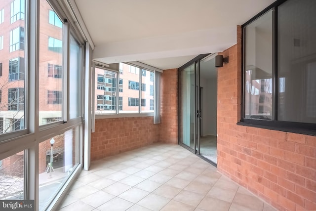 unfurnished sunroom with plenty of natural light