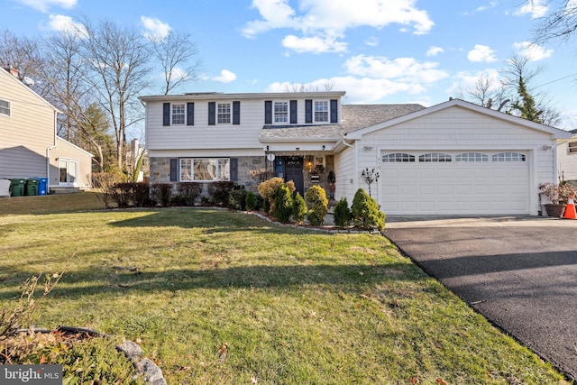 view of front of home with a garage and a front yard