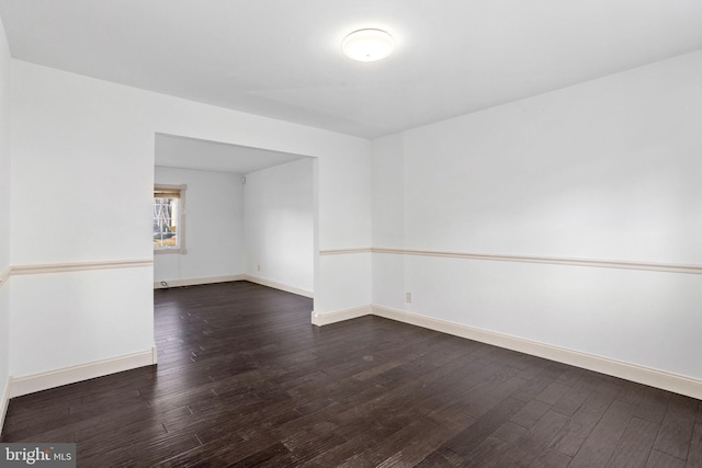 unfurnished room featuring dark hardwood / wood-style floors