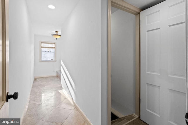 hall featuring light tile patterned flooring