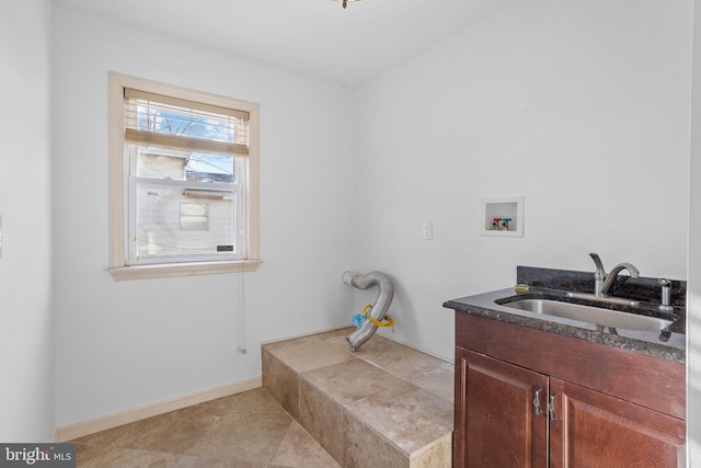 washroom with cabinets, hookup for a washing machine, light tile patterned floors, and sink