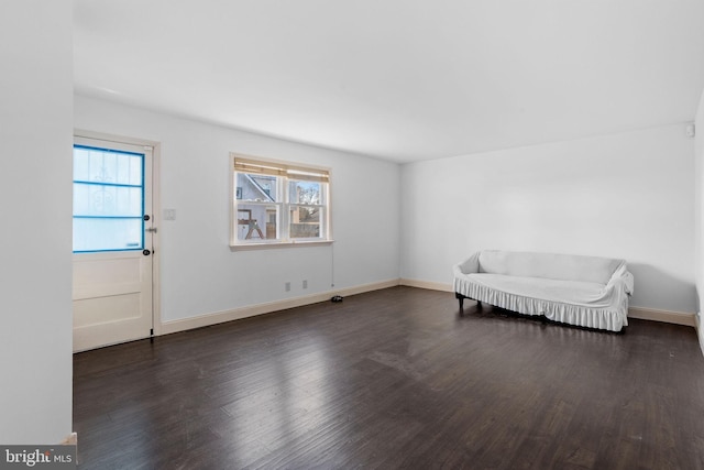 unfurnished room with dark hardwood / wood-style flooring