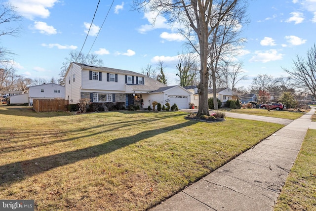 view of front of house with a front yard and a garage