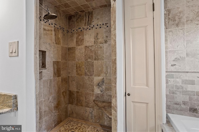 bathroom with a tile shower